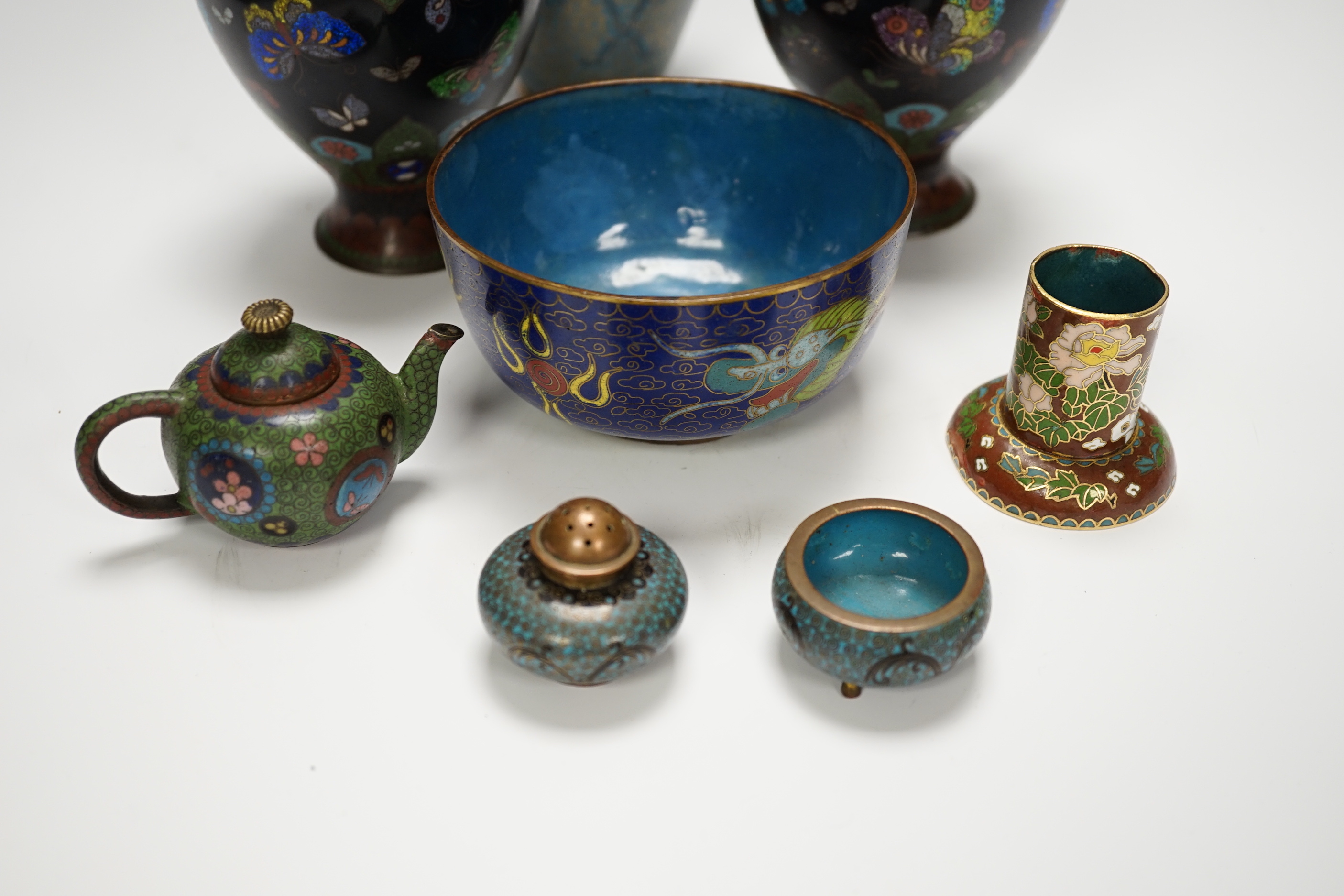 A collection of Chinese and Japanese cloisonné enamel pieces, including five vases, a ginger jar and cover, three bowls, a miniature teapot, napkin rings, etc. (19)